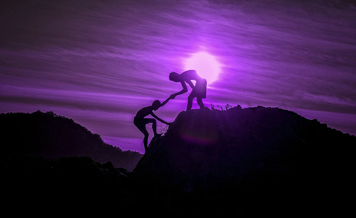 man helping man under purple sky trinity esoterics
