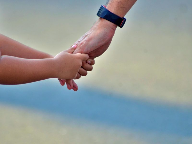child clinging to adult's hand trinity esoterics