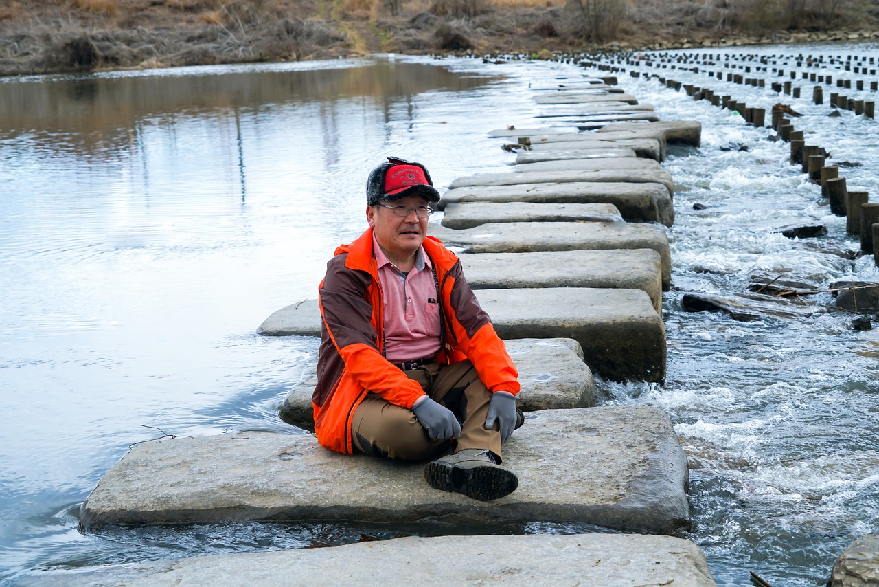 man sitting in the middle of stepping stones trinity esoterics