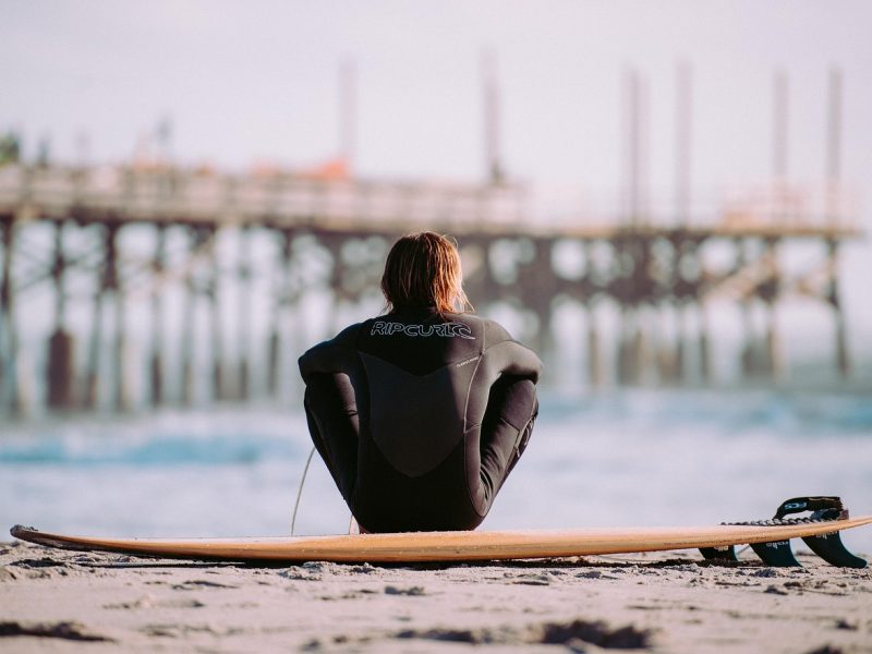 surfer on the shore trinity esoterics