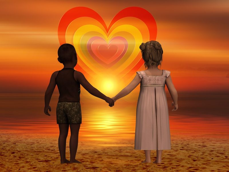 children holding hands looking at heart in the sky trinity esoterics