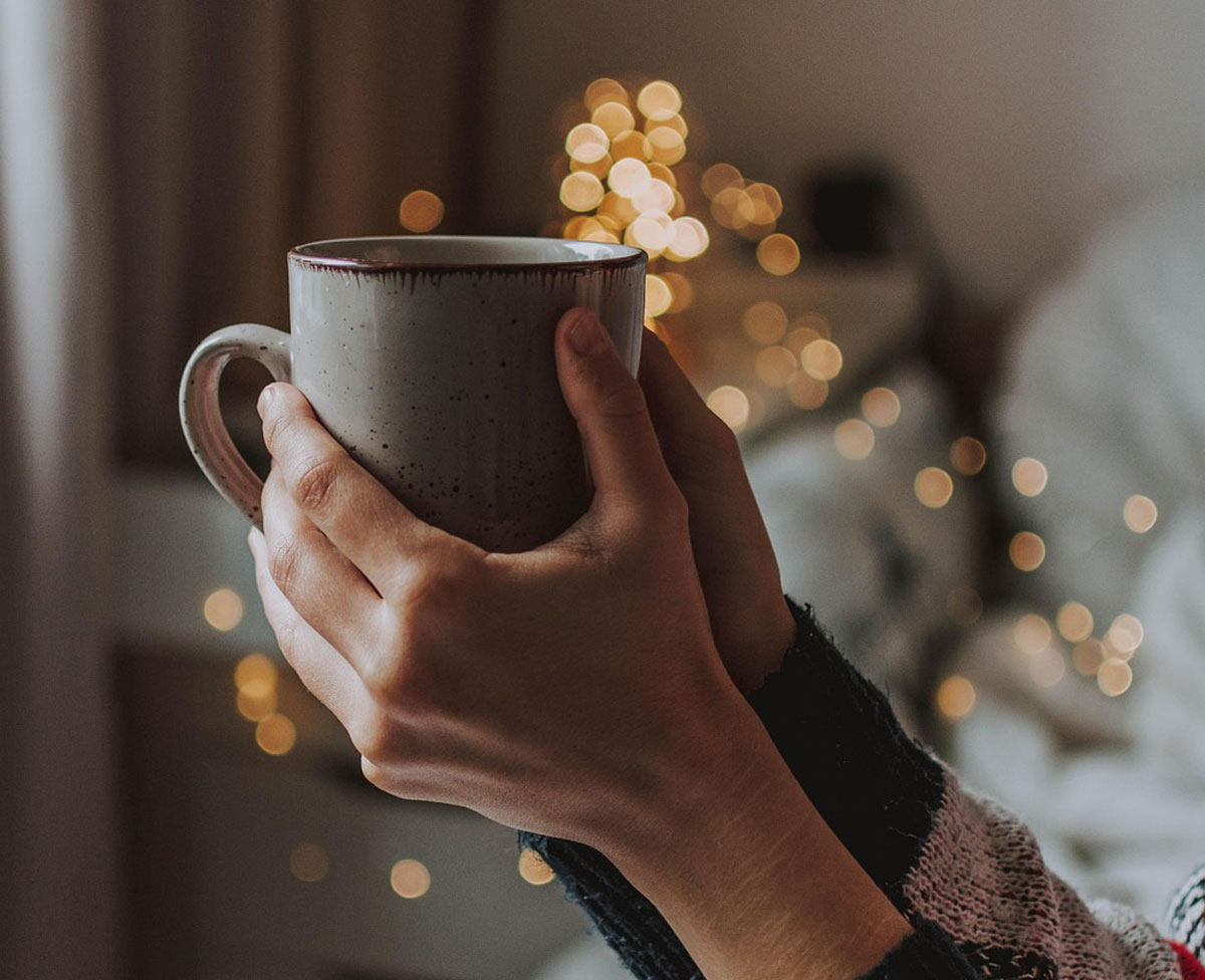 person with cup overflowing with light trinity esoterics