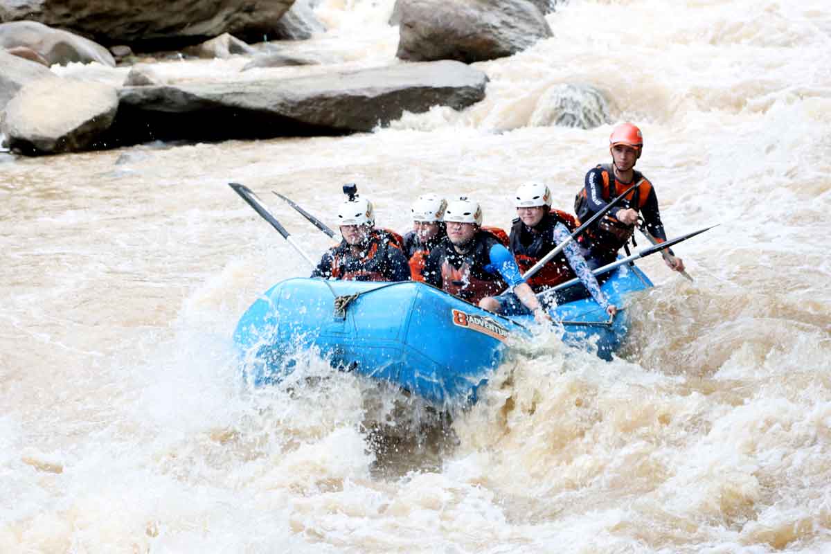 people in raft in rapids trinity esoterics