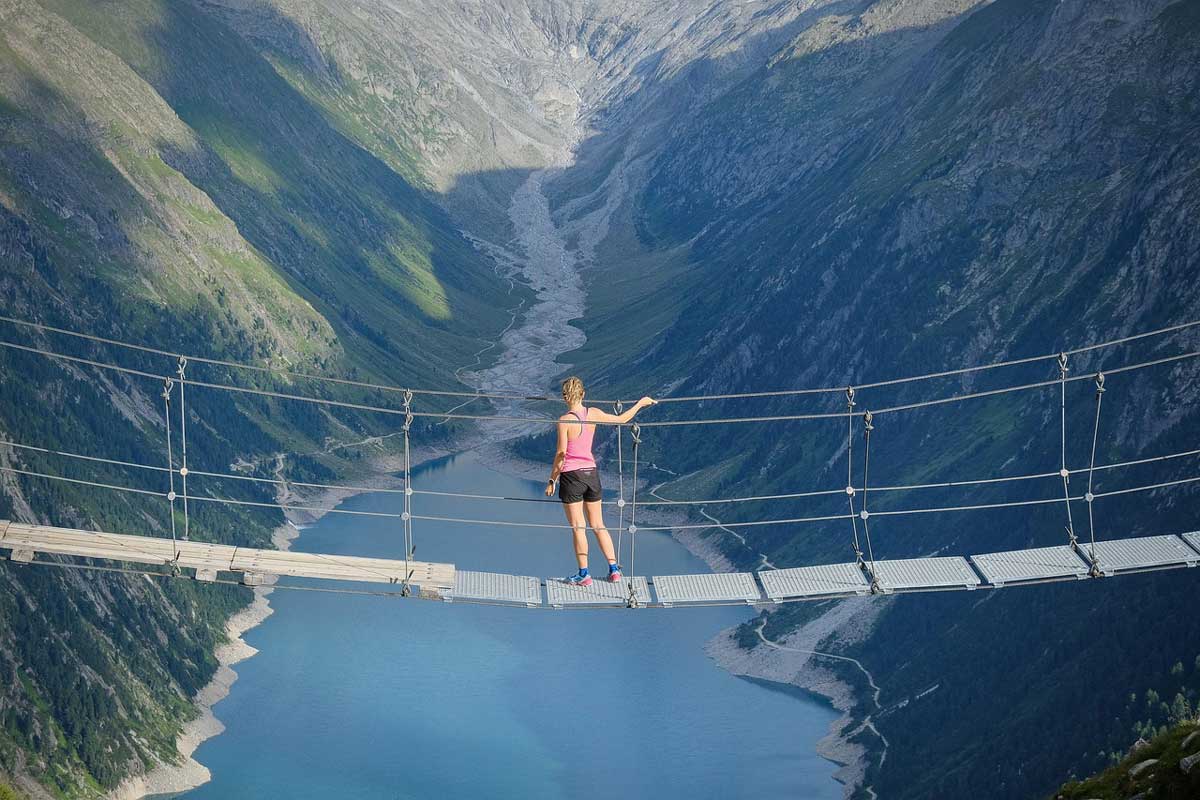 person on suspension bridge trinity esoterics