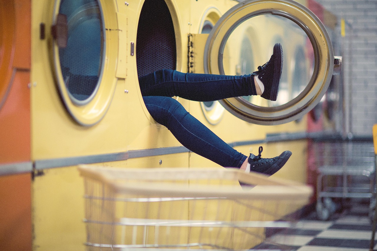 legs sticking out of a machine at a laundry mat trinity esoterics