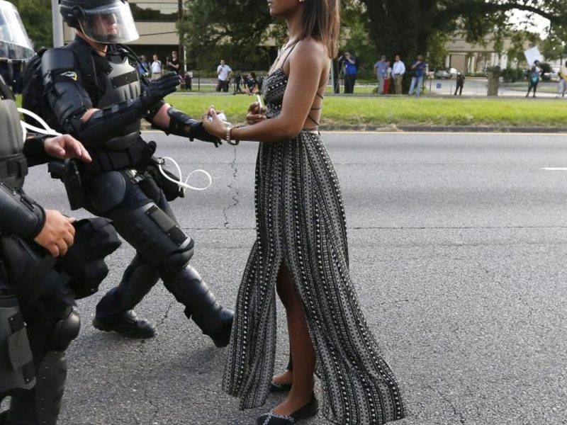 empowered woman standing in front of police