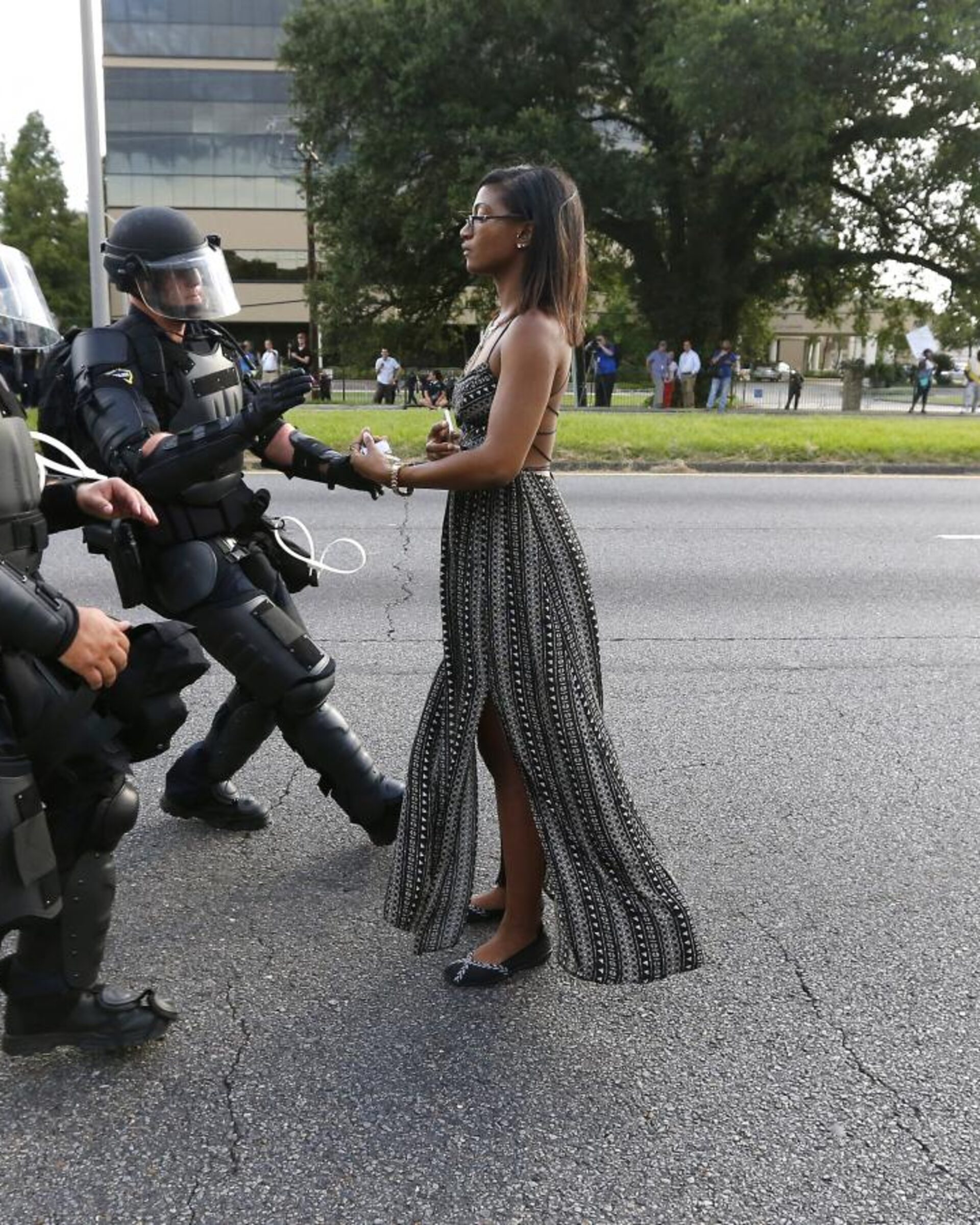 empowered woman standing in front of police